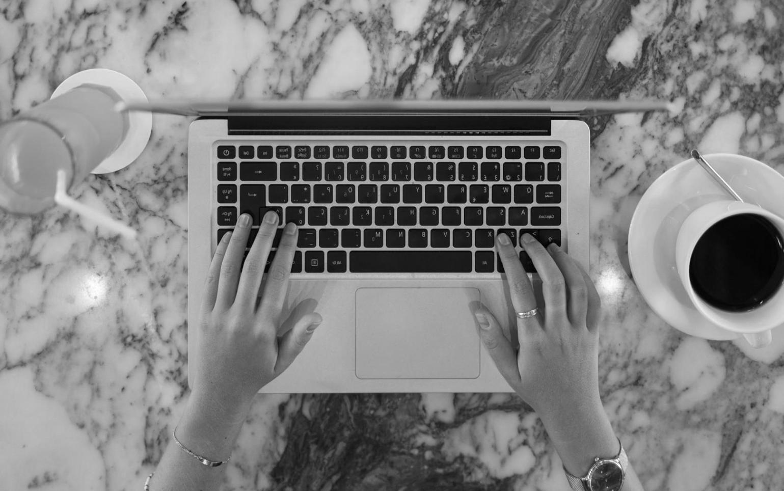 Student working on budget planning with laptop and documents
